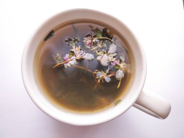 Seramik fincanda tıbbi bitkiler bulunan doğal bitki çayı.