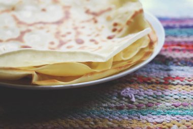 Ülke çizgili ev yapımı paspas arka planında bir yığın lezzetli krep.