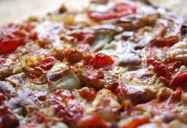 Rustic pizza with salami, tomatoes and cheese