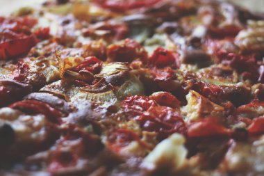 Rustic pizza with salami, tomatoes and cheese