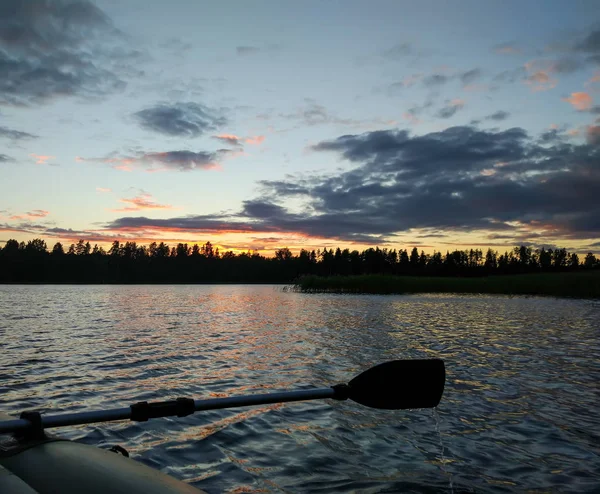 Landscape with lake surface and fragment of paddle of inflatable boat. — Stock Photo, Image