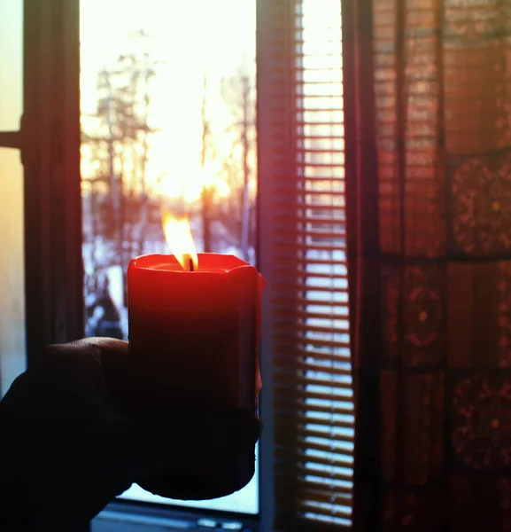 Red Burning Candle Hand Winter Sunrise Background — ストック写真