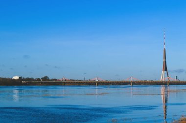 Urban landscape with bridge, modern buildings and blue sky in october.
