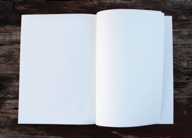 White paper sheet on the wooden table outdoors