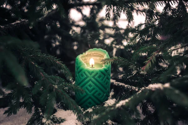 Christmas decoration - green candles and fir tree branches