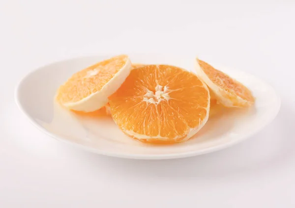 Naranja en rodajas en un plato blanco — Foto de Stock