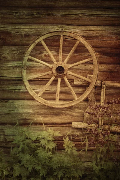 old wooden wheel near house