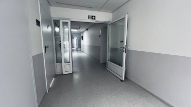 Szczecin, Poland- July 31 2025 : Quiet hospital corridor with glass doors and modern design. Clean, bright, and sterile environment, perfect for medical facilities. 