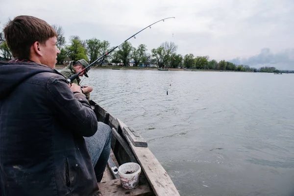 Des pêcheurs attrapent du poisson assis dans le bateau — Photo