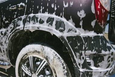 Car in the foam. Car wash. Car in the foam from cleaning agent