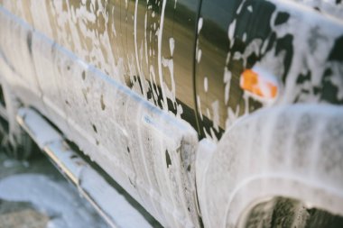 Car in the foam. Car wash. Car in the foam from cleaning agent