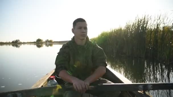 Young Man Swims On A Wooden Boat And Rowing With Oars. — Stock Footage Young Man Swims Wooden Boat Rowing Oars Stock Footage
