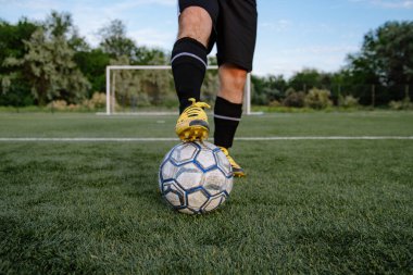 Futbol sahasında topu olan futbolcuya yakın durun. Futbol sahasında topu olan erkek futbolcu. Futbol sporu kavramı.