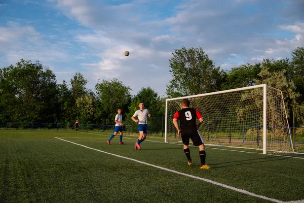 Soccer player kicks the ball.Soccer player takes a corner kick.Football player kicks the ball on the football field.Football sports concept