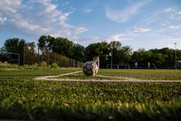 Soccer player kicks the ball.Soccer player takes a corner kick.Football player kicks the ball on the football field.Football sports concept