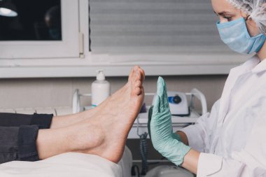 Spa salonundaki rahatlama pedikür sürecine yakın çekim. Genç bir kadın güzellik salonunda profesyonel pedikür yaptırıyor. Pedikür sırasında yüksek lisans yapıyor. Profesyonel pedikür süreci.