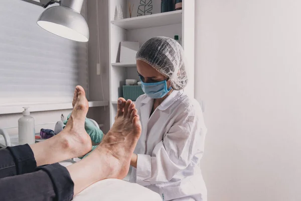 Close-up of relaxation pedicure process in spa salon.Young woman getting professional pedicure in beauty salon.Master during a pedicure. The process of professional pedicures.