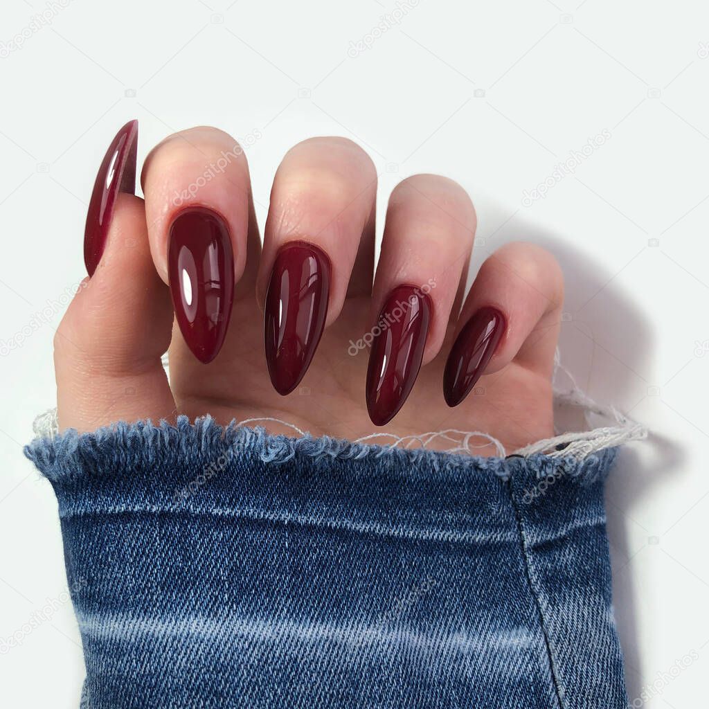 Red manicure. Hands of a woman with red manicure on nails.Manicure beauty salon concept. Empty place for text or logo.