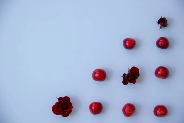 成熟的甜樱桃 白色背景上芬芳的红玫瑰 — 图库照片