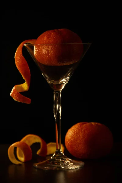Reife Mandarine Liegt Einem Martini Glas Auf Schwarzem Hintergrund Orangefarbene — Stockfoto
