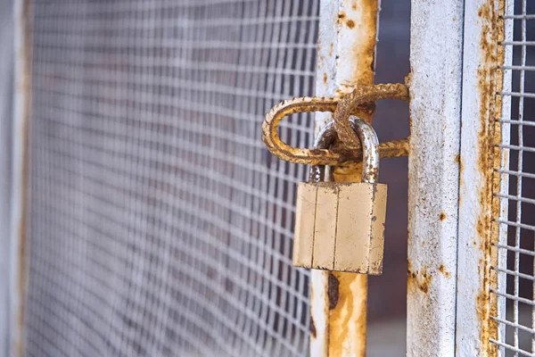 Locked gates with old rusty lock