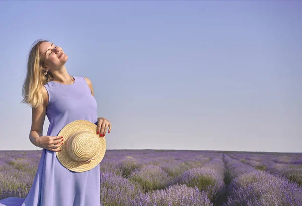 cute woman faces the sun on a lavender field