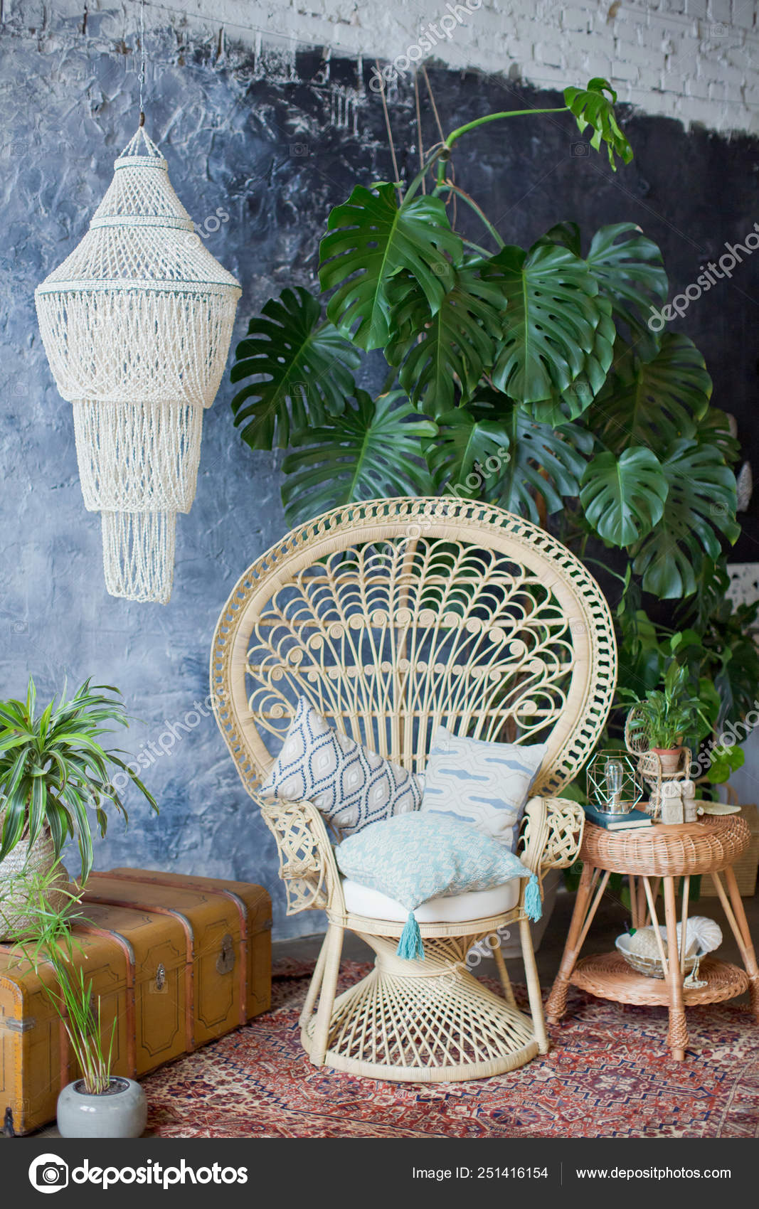 rattan peacock chair and big monstera plant in loft room 251416154