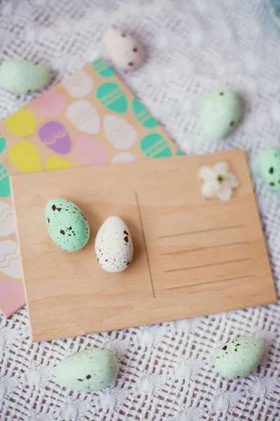 Colorful easter eggs and wooden postcard — Stock Photo, Image