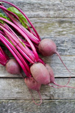 Kırsal ahşap arka planda yaprakları olan taze organik pancar. Üst görünüm
