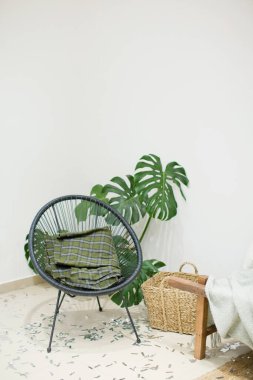 Boho 'nun içi eski sandalye, canavar ve rattan sepetli.