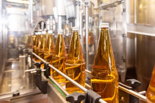 Filling bottles with juice. Bottling of drinks. bottling plant