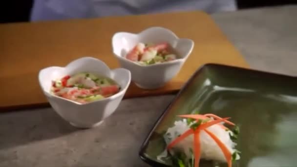 Pan neer als chef-kok plaatsen vier garnalen tempera op serving plaat met komkommer salade aan de zijkant. — Stockvideo