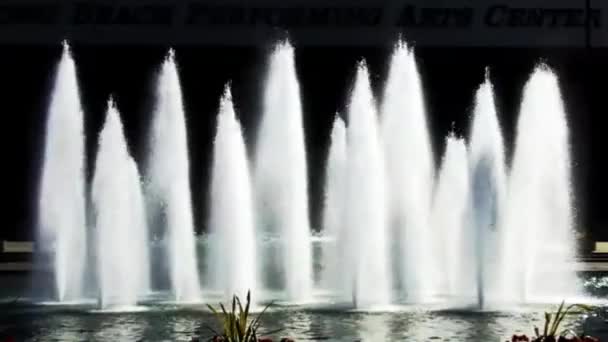 Relajantes chorros de agua brillan bajo el sol en una moderna fuente urbana en Long Beach — Vídeo de stock