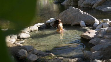 Girl Flipping Hair in water at deep creek hot springs clipart