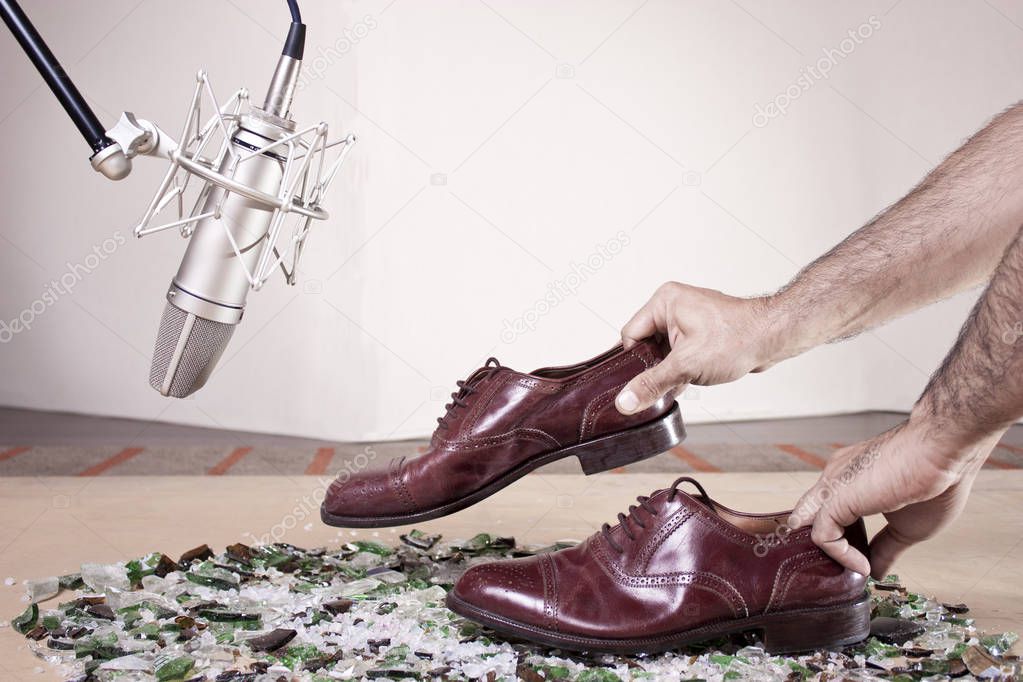 Caucassian male hands with male dress shoes moving on broken gla