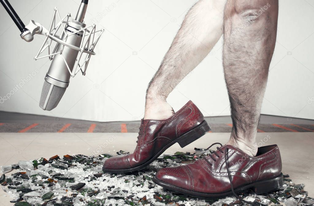 Foley man steps with soundman hands inside the dress shoes. Shoe