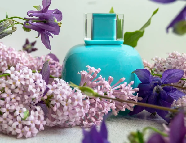 A jar of perfume with purple liliac flowers — Stock Photo, Image