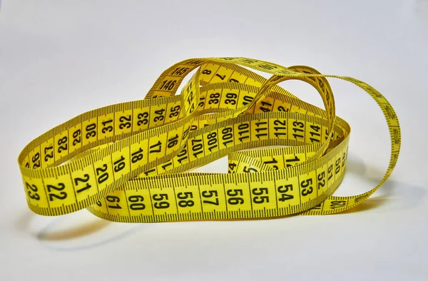 Slim concept with scale and measuring tape on white background — Stock Photo, Image