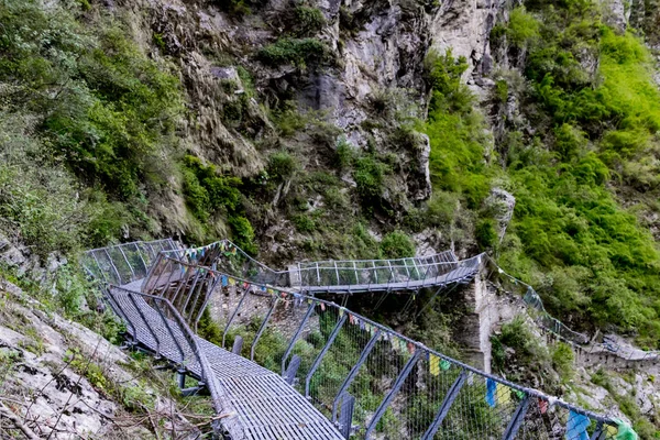 Cantilever Bridge constructed of two cantilevers that meet in the middle. Cantilever bridge hold at the tough stone hill in the Manaslu Region is the one and only in Nepal.