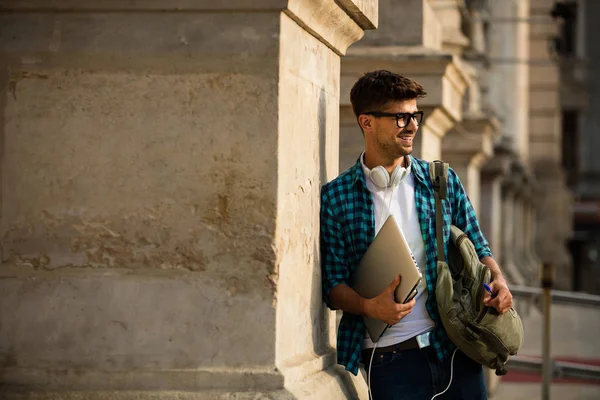 Joven Estudiante Con Gafas Mochila Apoyado Con Portátil Manos Colmn — Foto de Stock