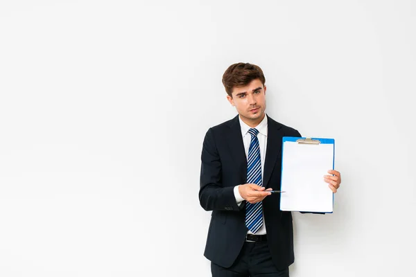 Confident Businessman Suit Showing His Clipboard Camera Smiling Standing White — Stock Photo, Image