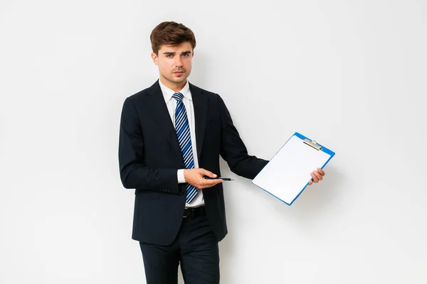 Confident Businessman Suit Showing His Clipboard Camera Smiling Standing White — Stock Photo, Image