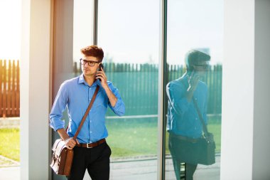 Genç antrepreneur güneşli bir gün, mavi gömlekli işadamı ofise gidiş