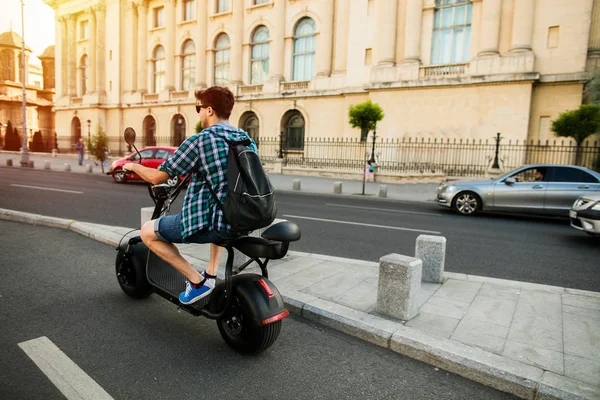 Jazda Mieście Szczęśliwy Młody Człowiek Plecaka Jedzie Jego Skuter Elektryczny — Zdjęcie stockowe