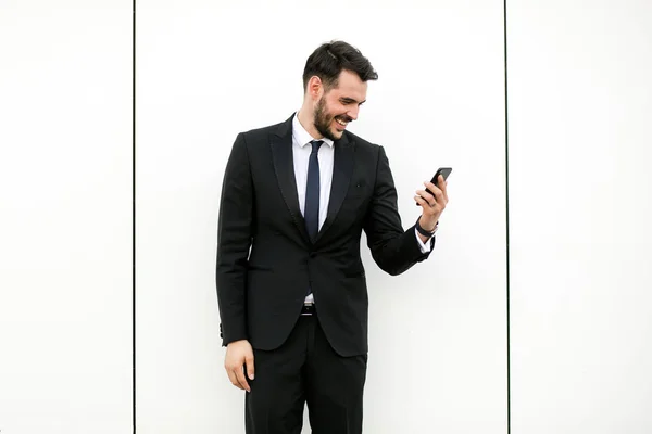 Bonito Elegante Homem Terno Usando Seu Celular Sorrindo Recebendo Boas — Fotografia de Stock