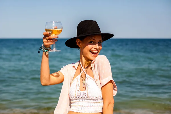 summer vibe and party girl with hat, at a summer party on a beach with cocktail having fun