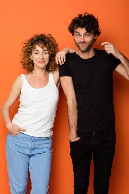 turuncu zemin üzerine komik genç çift