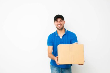 sevinç ve gülümseme, beyaz arka plan ile tarafında paket sunan kibarca teslimatçı