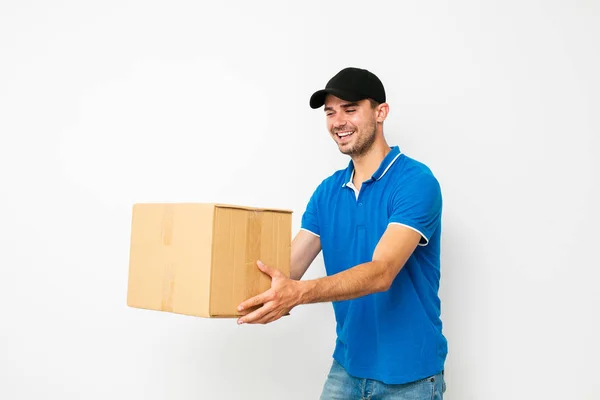 Politely Delivery Man Offering Package Side Joy Smile White Background — Stock Photo, Image