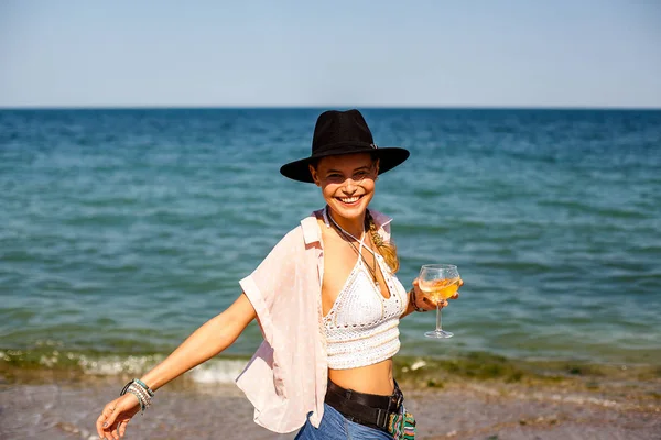 şapkalı bir yaz partide eğleniyor kokteyl ile bir plajda yaz vibe ve parti kız